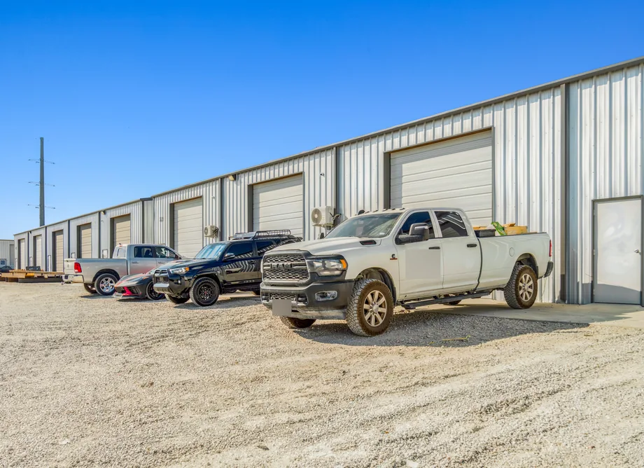 Pickups parked at a row of roll-up doors at United Flex Anna